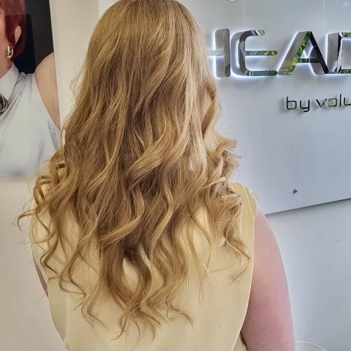 HEADS client with long blonde waves after extensions, back view — Extensions by HEADS