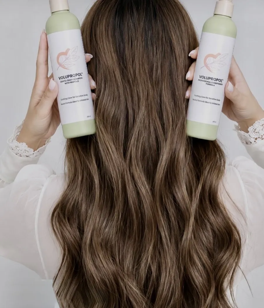 Volupropol shampoo and conditioner held beside healthy hair